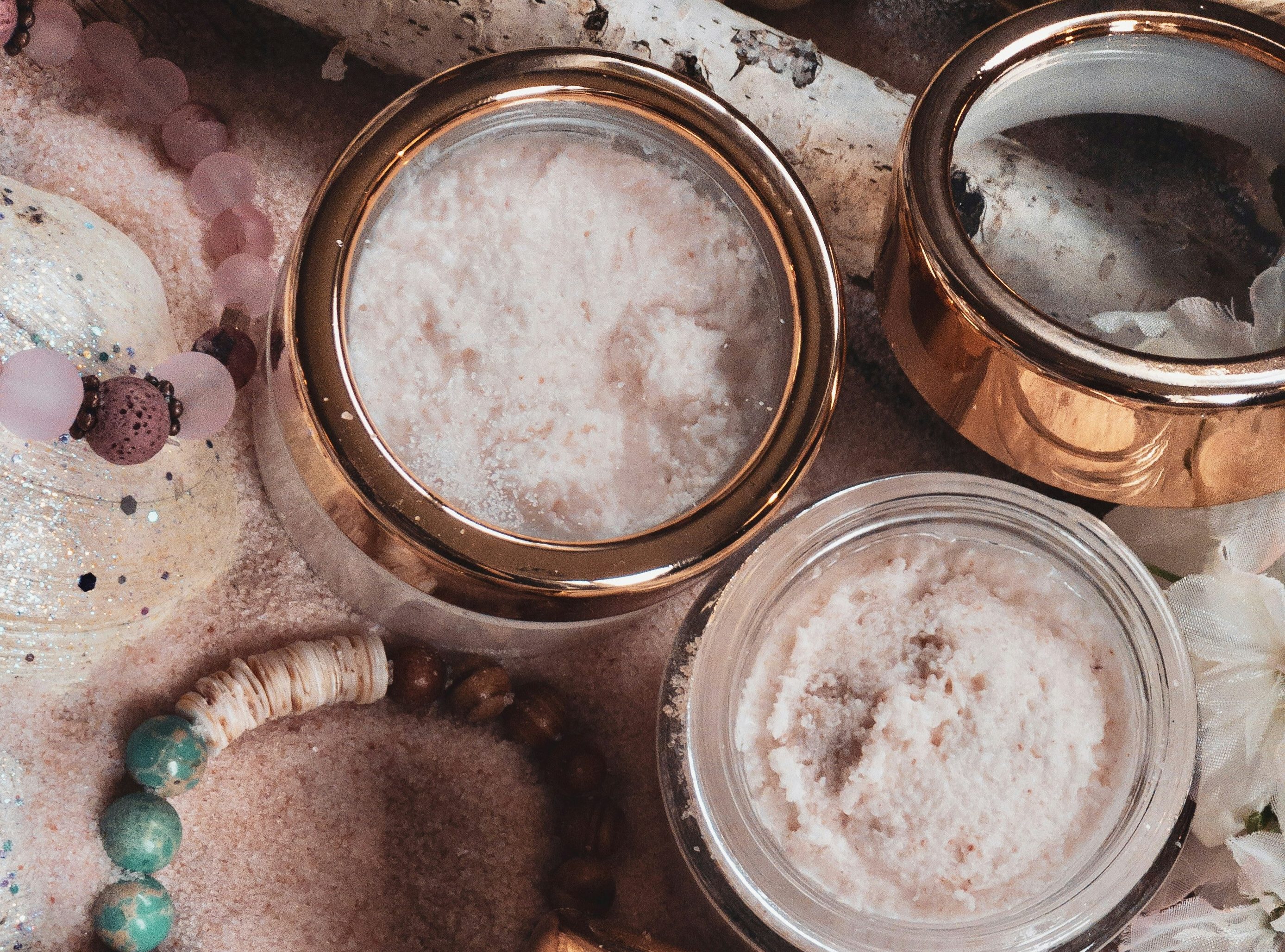 Small jars with gold lids filled with sugar
