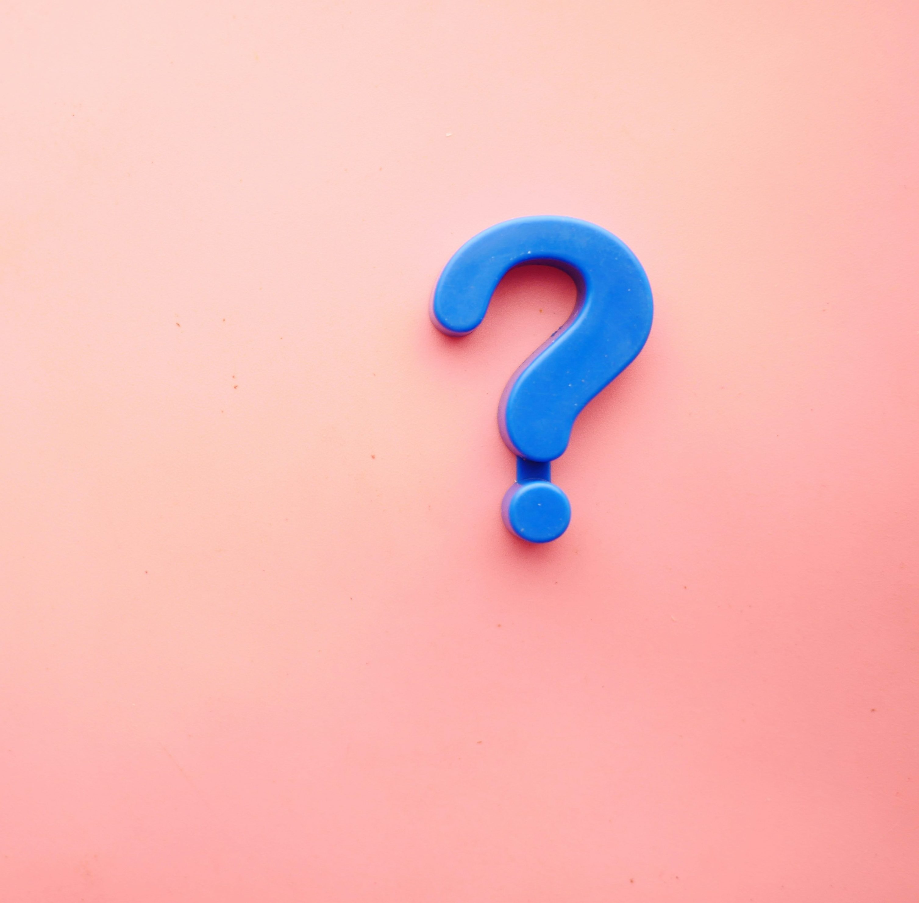 blue 3-d question mark against a soft pink background